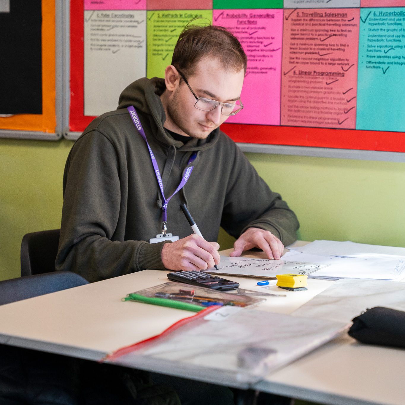 A student working through maths with a calculator