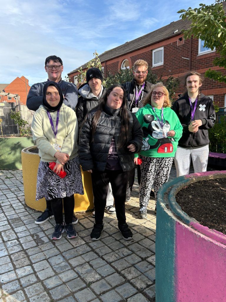 Supported volunteer interns standing together in Red Lion Park, Redcar