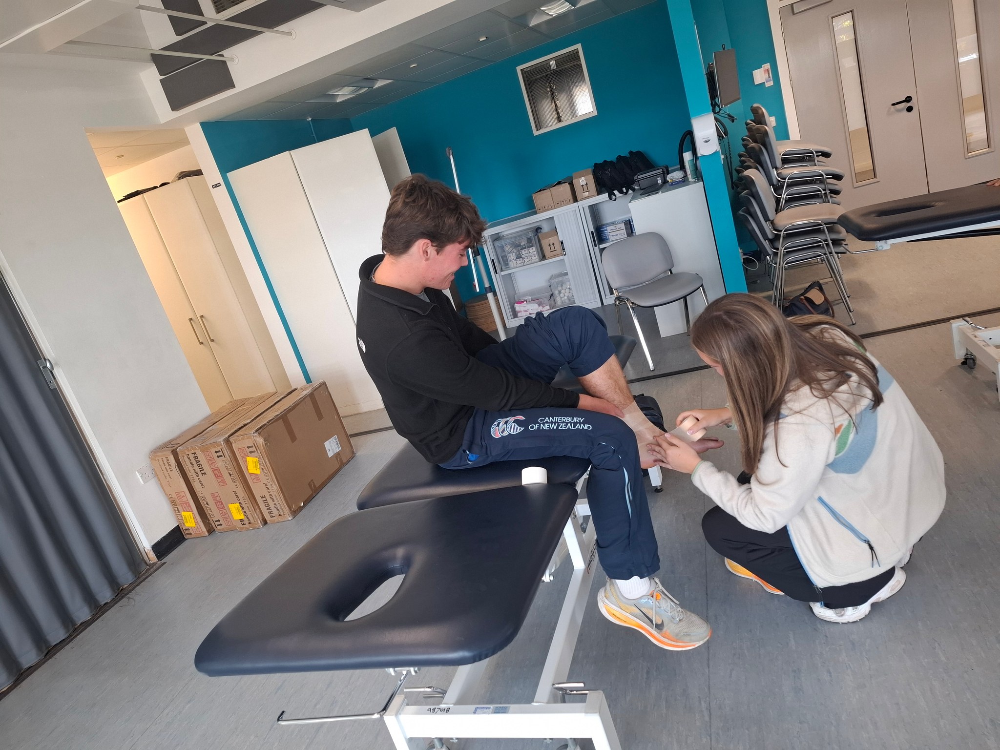 A Prior student practises strapping another student's ankle in the rehab lab at Teesside University